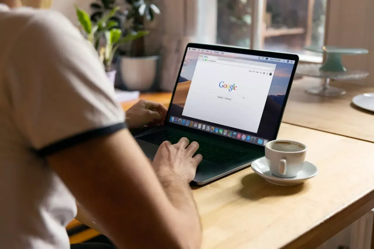 person typing on laptop and searching something on google